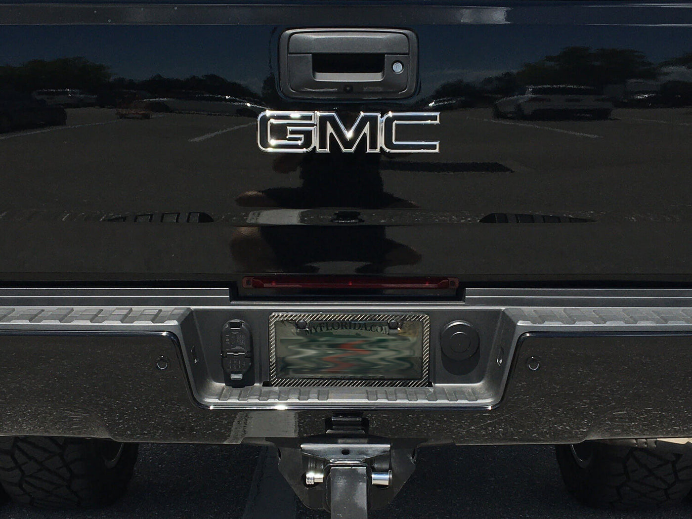 Smoke window carbon fiber license plate frame on GMC truck