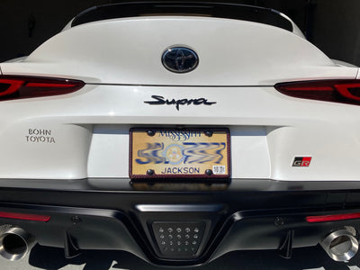 Red carbon fiber license plate from on a 2021 Toyota Supra GR