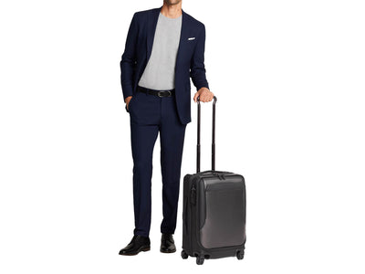 Tumi International Dual Access 4 Wheeled Carbon Fiber Carry-On Suitcase, with person
