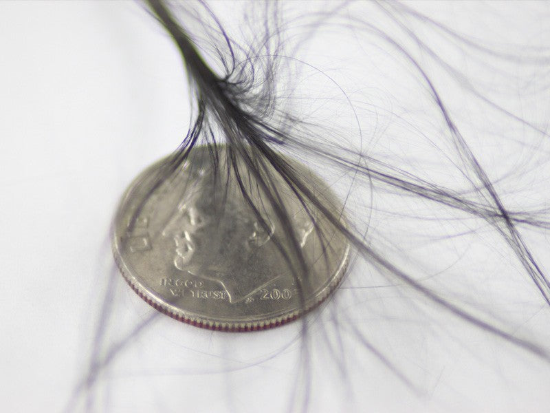 Carbon fiber strands compared to a coin